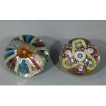 Two antique paperweights, the first inset with millefiore canes in yellow, red and white in an