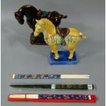 Two pottery Chinese style horse figures, one glazed in yellow, brown, green and on a blue base,