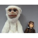 A Norah Wellings monkey, white plush and fawn velvet face, feet and hands, approximately 24cm, label