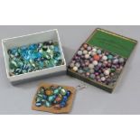 A collection of vintage marbles to include shades of green to blue with a white swirl (approximately