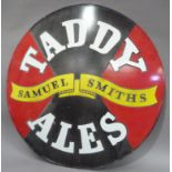 A 'Taddy Ales' Samuel Smith Brewery enamel sign, circular, white lettering on black and red