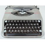 A Hermes portable typewriter by Paillard in grey metal case