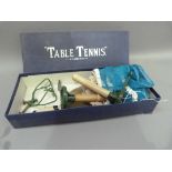 A vintage Table Tennis set containing two bats, one ball, one net and a pair of posts with table