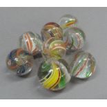A collection of eight vintage marbles, two with solid core in orange and white and in green,