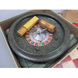 A wooden chess set in original box together with a roulette wheel, dice and boxwood shaker,