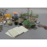 A Britains plastic model toy garden with hedgerows, shrubs and plants, greenhouse, flowerberds,