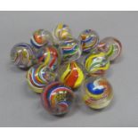 A collection of twelve vintage marbles to include two with solid white core, two with yellow, red