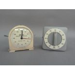 A Smiths Fishing Clock Systems cream metal clock with seconds timer, together with a Junghans