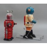 South Pole Explorer B-17 skier tin plate clockwork robot, 21.5cm high, together with Moon Explorer