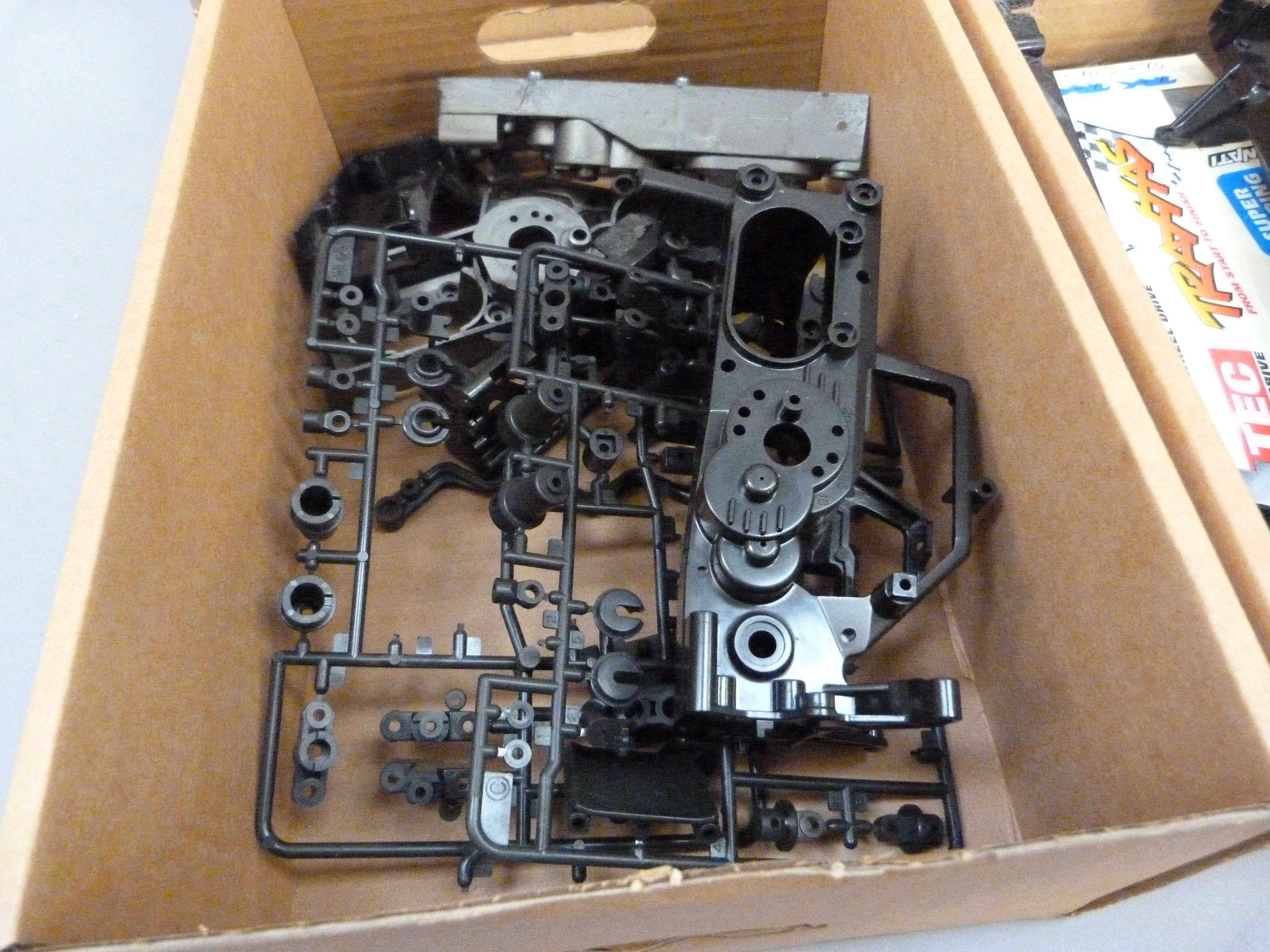 A quantity of spare model parts to include plastic mouldings, chassis, etc. in four boxes (4)