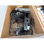A quantity of spare model parts to include plastic mouldings, chassis, etc. in four boxes (4)
