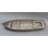 An early 20th century wood and copper bound model of a rowing boat (one half seat off but
