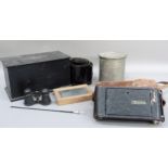 A vintage Kodak film tank, a Kodak wooden film tank, a box of assorted black paper masks and discs