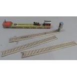 An Arnold (Germany) tinplate clockwork train set comprising locomotive and carriage for reserve