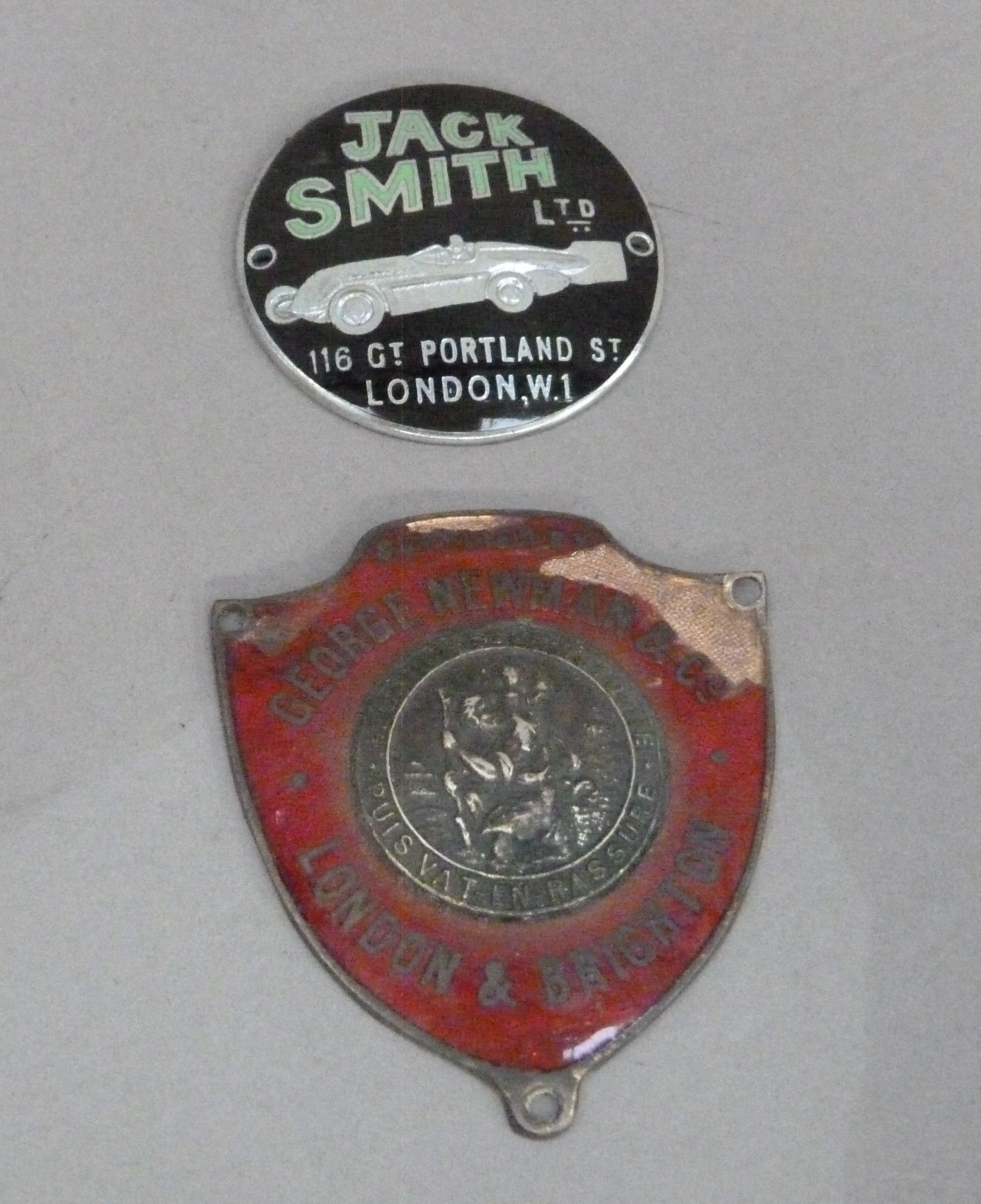 A 1930s Jack Smith Ltd dashboard badge, 116 Gt Portland St London W1, black and green enamel with