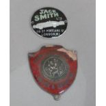 A 1930s Jack Smith Ltd dashboard badge, 116 Gt Portland St London W1, black and green enamel with