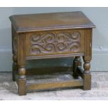 A small oak work box having a hinged lid over foliate scrolled panels on turned and square framing