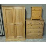 A modern pine two door wardrobe, chest of two short and three long drawers and bedside chest of