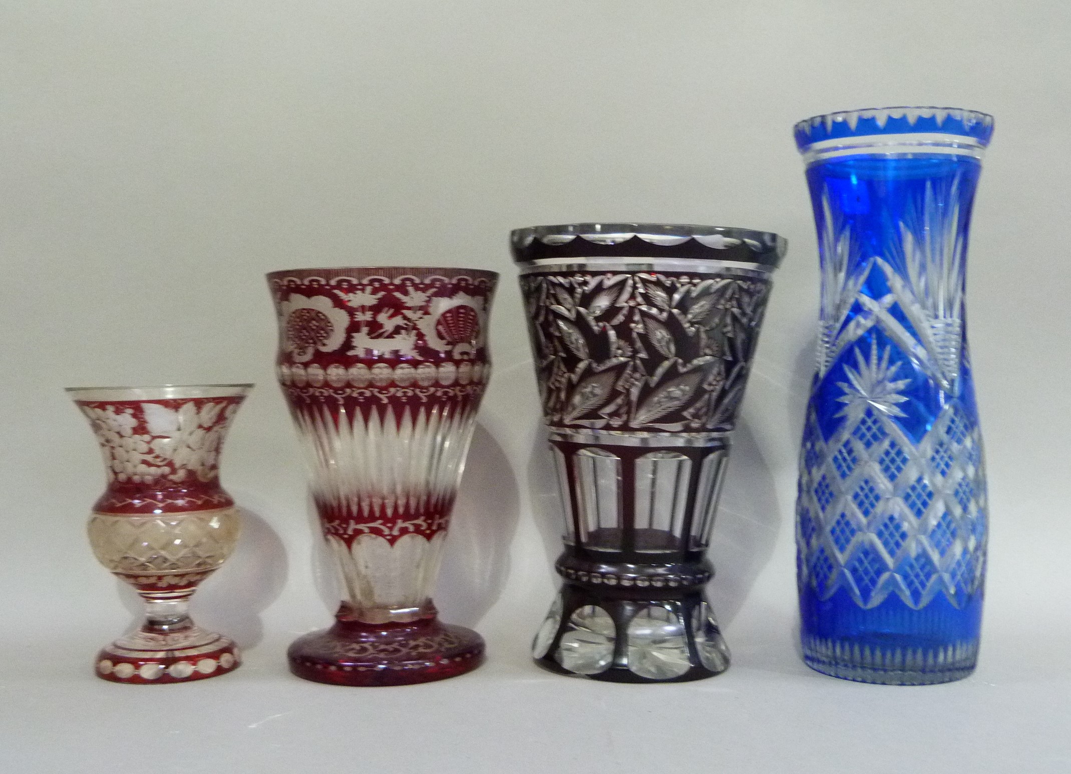 Four coloured and clear cut glass flower vases in ruby, blue and dark red, 32cm x 25cm, 23cm and - Image 2 of 2