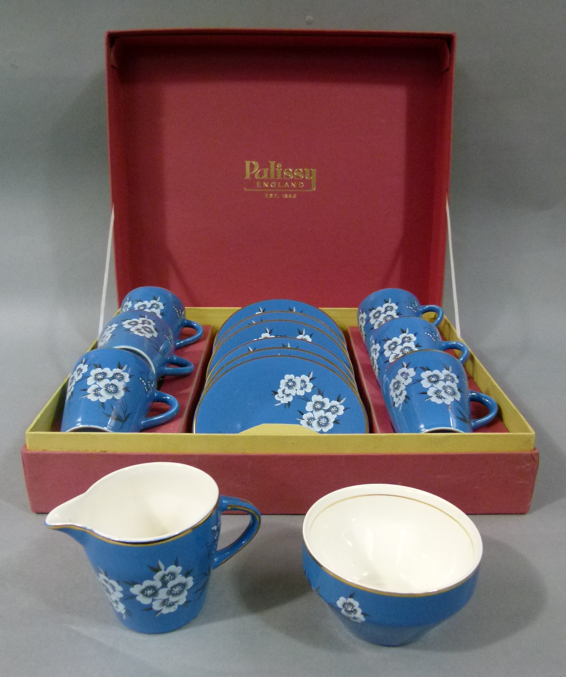 A Palissy boxed tea set of Canton design, six cups, six saucers, sugar and cream, transferred with