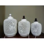 Three Chinese white glaze reticulated vases pierced with cherry blossom trees of graduated size,