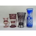 Four coloured and clear cut glass flower vases in ruby, blue and dark red, 32cm x 25cm, 23cm and