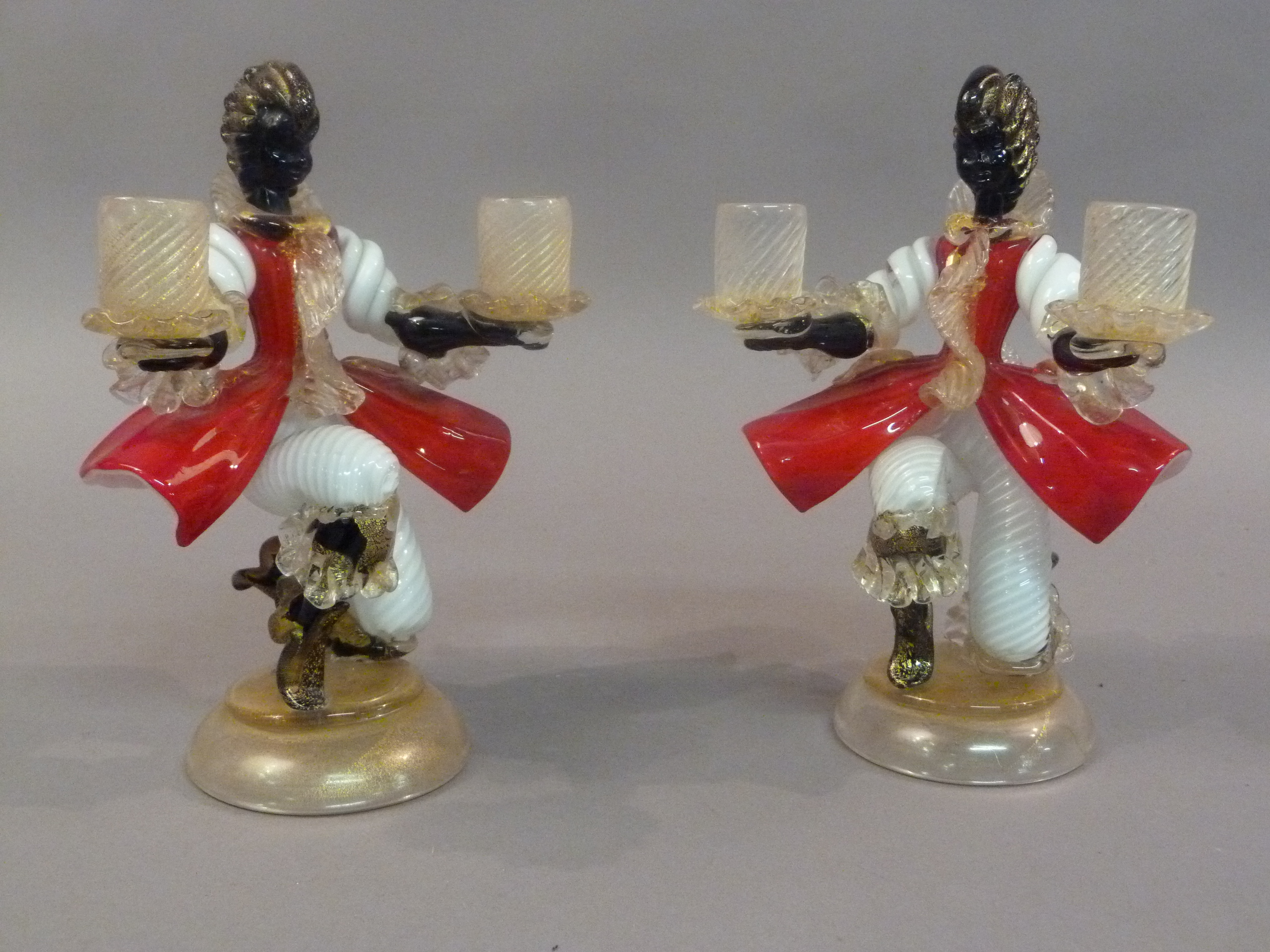 A pair of Murano glass figural twin sconce candlesticks, each female figure in black, red, white
