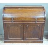 A 19th century mahogany cylinder bureau the interior fitted with small drawers, pigeon holes and a