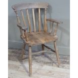A reproduction slat back kitchen armchair, dish seat on turned legs joined by a stretcher