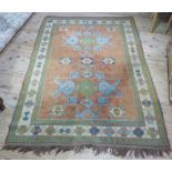 A Caucasian rug with a stepped design of coral ground within multiple borders in shades of blue,