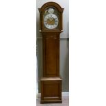 A 19th century oak long case clock having an arched brass dial with silvered chapter ring Roman