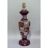 A cut glass and red flashed table lamp cut with panels of flowers, baluster form, 43.5cm high to top