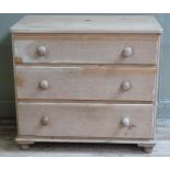 A pine chest of three graduated drawers with turned handles and feet