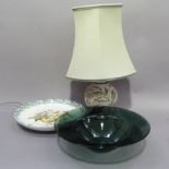 A large handmade green glass fruit bowl, a large pottery fruit platter and a potter table lamp