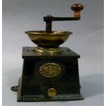 A 19th century brass mounted black lacquered iron coffee mill by Baldwin Son & Co