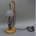 A modern table lamp with reproduction pottery model of a Chinese terracotta soldier standing on a