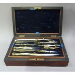 A 19th century rosewood cased set of drawing instruments the cover having a vacant brass