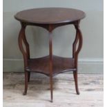 An Edwardian mahogany circular occasional table on six legs joined by an undertier