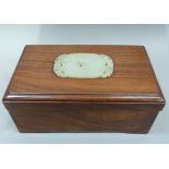 A Chinese hardwood box inlaid to the lid with a jade plaque, rectangular measuring 17cm x 10cm x 7cm