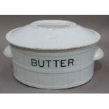 An early 20th century white glazed pottery butter dish the domed top with integral handle,