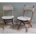 A pair of stained beech and rope woven folding chairs