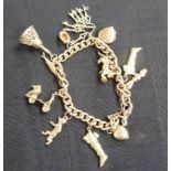 A curb link bracelet in silver hung with eleven charms