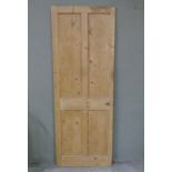 A vintage pine four indented panel door, stripped
