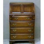 A reproduction oak bureau having a fall front over four drawers