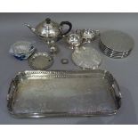 A three piece silver plated tea service together with a foliate chased two handled rectangular tray,