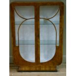 An Art Deco figured walnut and glazed two door display cabinet