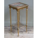 An onyx inset and gilt etagere with bergere undertier on slender fluted legs