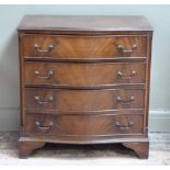 A reproduction mahogany serpentine fronted chest of four drawers on shaped bracket feet