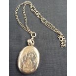 A Victorian silver locket engraved with M K 1 monogram, approximately 44mm x 36mm, pendant loop