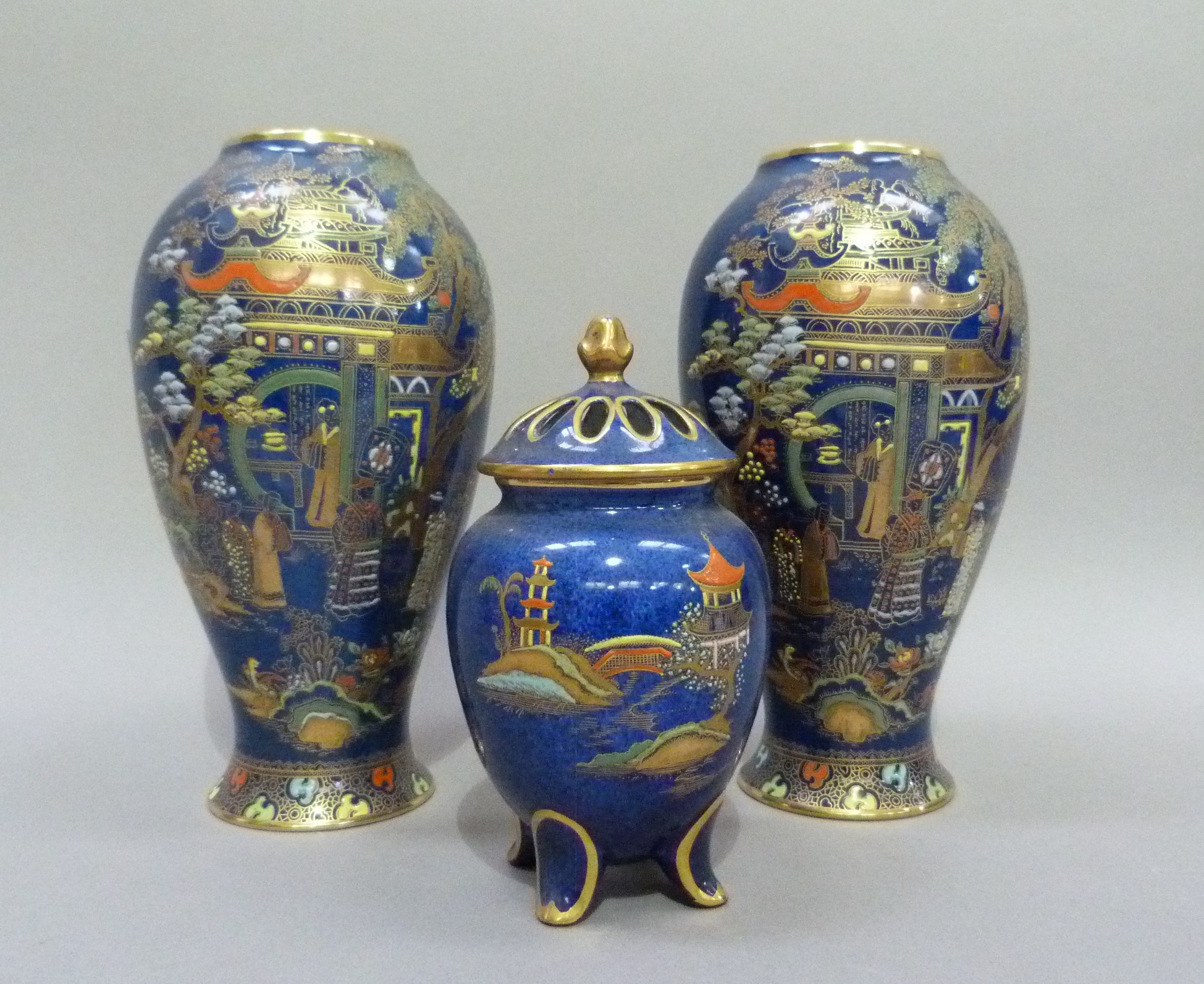 A pair of Carlton ware baluster vases printed in gilt and enamelled on a blue ground with a